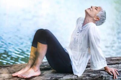 Ageless Active senior woman practicing mindfulness by the water